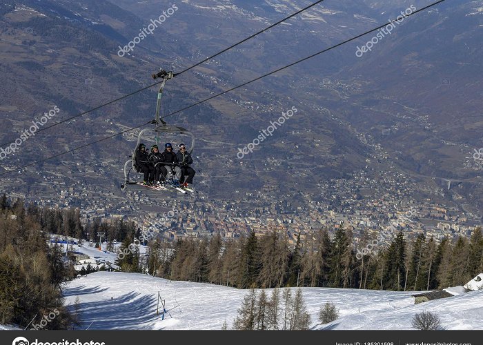 Cable Car Pila Four middle aged men skiers take a chair lift up the mountain at ... photo