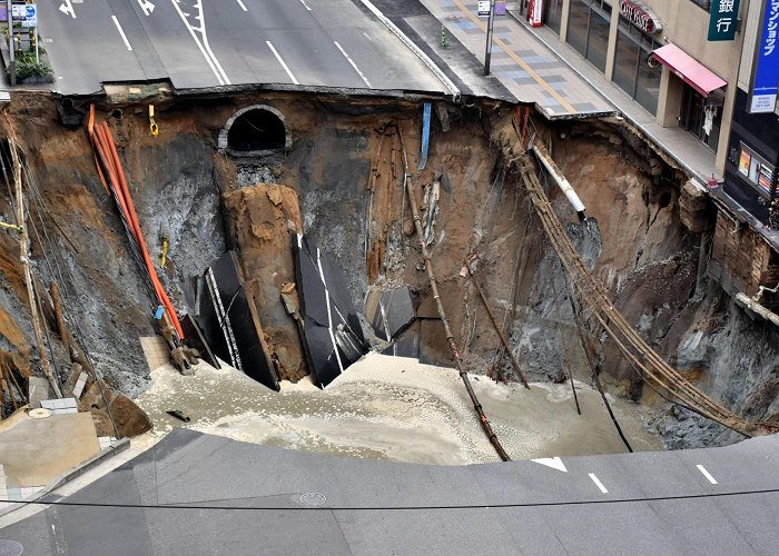 Hakata Station Huge street sinkhole disrupts services, forces evacuations near ... photo